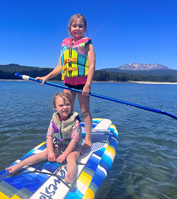 Two youngsters enjoy their time in the water while exhibiting good water safety behavior by wearing life jackets. submitted photo