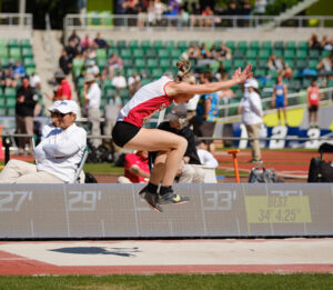 Santiam High’s Averie Peterson flies through the air during the triple jump Friday, May 17 at the Class 2A state track and field championships at Hayward Field in Eugene. Peterson won the event and set a personal best.          Submitted