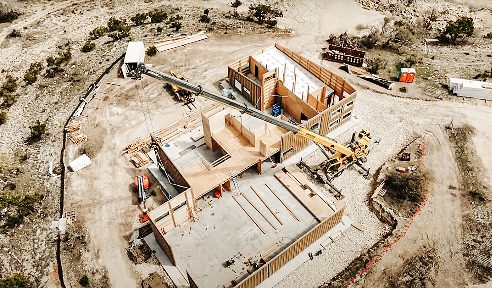 This is an overhead view of a house under construction in Dripping Springs, Texas, about a half hour from Austin. Freres Engineered Wood of Lyons produced every structural element to the building, including new, larger mass plywood panels. TimberBLDR