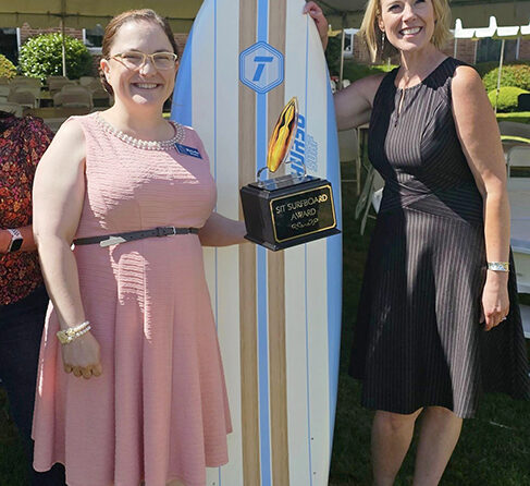 Melodie Weeks, left, shows off her Surfboard Award at the Friday, June 14, annual get-together of Santiam Hospital & Clinics’ Service Integration teams. At right is SIT coordinator Kim Dwer. SUBMITTED PHOTO